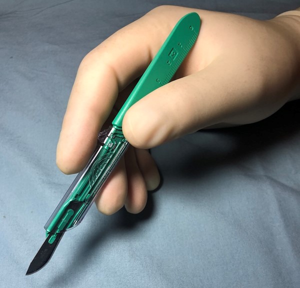 Holding a #10 blade scalpel